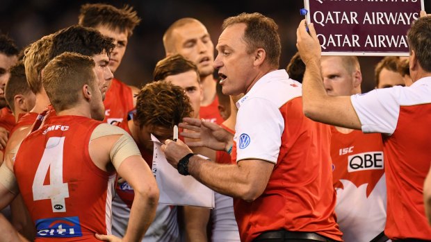 Crisis measures: An increasingly desperate John Longmire addresses the Swans during their semi-final loss to the Cats. 