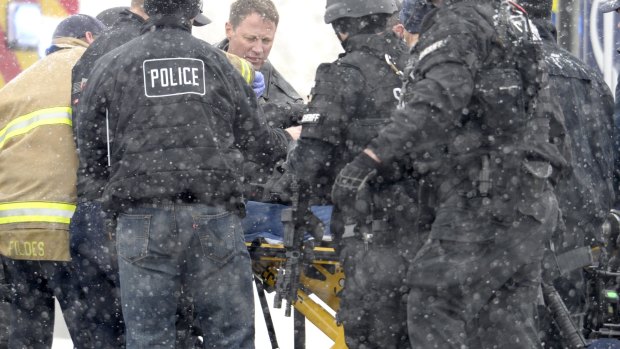 Emergency personnel transport an injured officer near the Planned Parenthood clinic in Colorado Springs on Friday. 