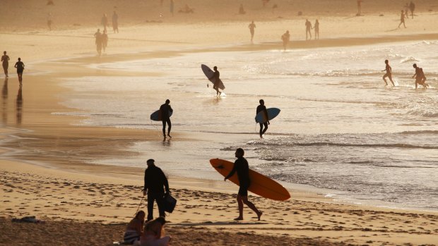Surfers enjoy the warm spring weather on Bondi Beach on Wednesday.