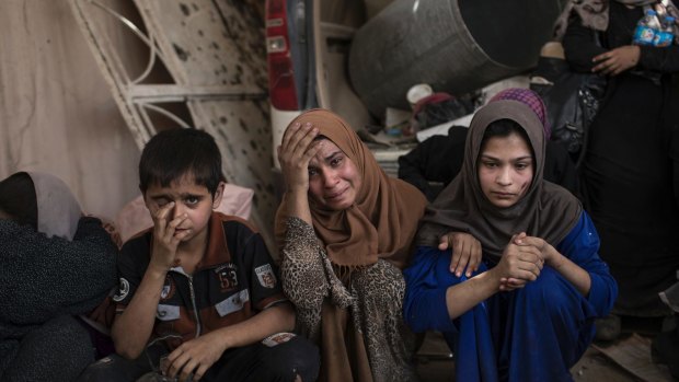Fleeing Iraqi civilians. Iraqi police and army units have relied heavily on air strikes to make progress, but this has resulted in high civilian casualties.