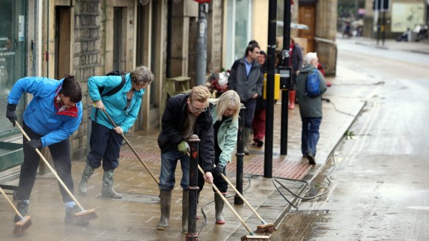 People continue the clean up effort, after the weekend's flooding, in Hebden Bridge, West Yorkshire.