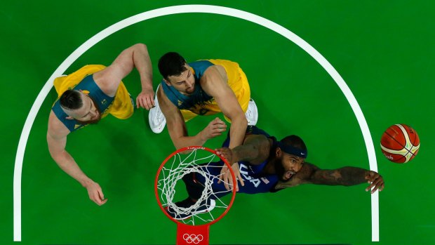 In the paint: US centre DeMarcus Cousins and Boomers duo Andrew Bogut and Aron Baynes go up for a rebound.