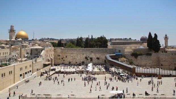 Visitors are seen at the Western Wall in Jerusalem's Old City. The area where non-Orthodox groups would pray under the 2016 compromise is to the right of the main plaza.  