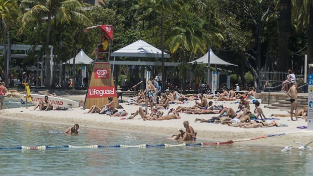 Despite the rest of South Bank being largely deserted, hundreds of tourists and Brisbane locals are spending their G20 public holiday at Streets Beach, 