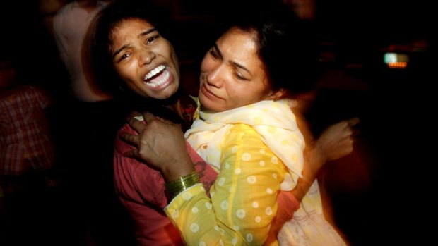 Distraught women hug one another following a suicide bomb attack in Lahore. 