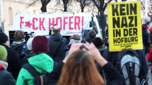 Demonstrators opposed to far-right candidate Norbert Hofer march through Vienna's city centre. The yellow placard says "no Nazis in the Hofburg (presidential palace)".