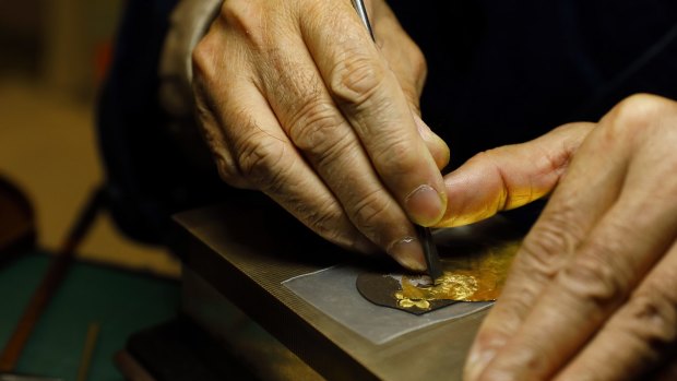 Working gold leaf for enamel at the Kyoto Museum of Traditional Crafts.