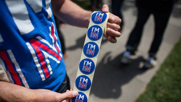 "I'm In" stickers handed to pedestrians in London on Monday. 