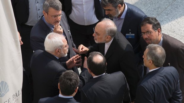 Iran's Foreign Minister Javad Zarif (centre on left) and the head of the Atomic Energy Organisation of Iran Ali Akbar Salehi (centre on right) talk outside with aides in March, after negotiations with US Secretary of State John Kerry about Iran's nuclear program.
