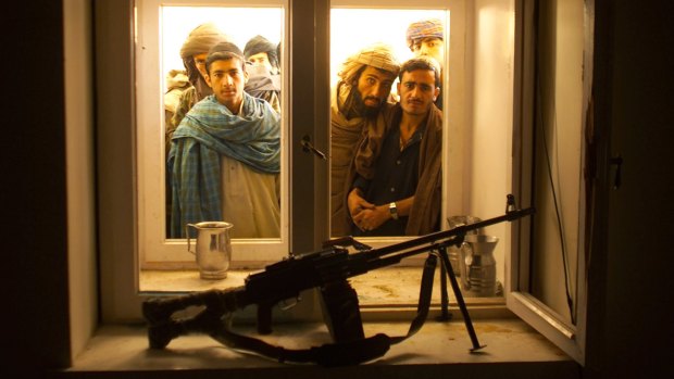 Afghans look through the window into the bedroom of Taliban spiritual leader Mullah Omar in his compound on the outskirts of the Afghan city of Kandahar in 2001.