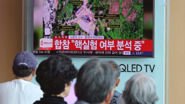 People in Seoul watch a TV news report about a possible nuclear test conducted by North Korea.
