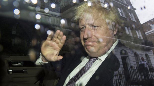 Former London Mayor Boris Johnson waves as leaves his home on Monday.