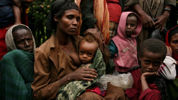Bussa Shalamo, second from left with her two children wait in a queue with 2000 strong crowd at a MSF Belgium outreach clinic in southern Ethiopia.