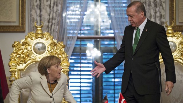Mr Erdogan offers his hand to German Chancellor Angela Merkel following a  meeting in Istanbul on October 18.