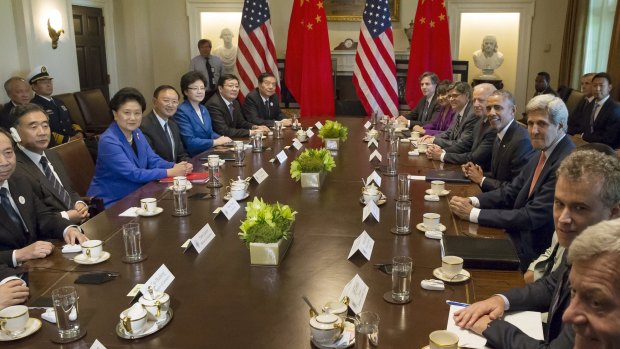 US President Barack Obama (4th R) and members of his cabinet with a Chinese delegation in Washington on Wednesday. China is one of 12 parties to the TPP. 
