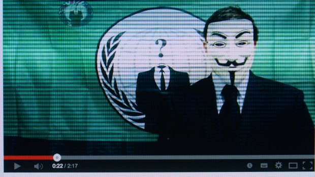 Video posted on youtube of an Anonymous member in a Guy Fawkes mask in front of the group's flag. 