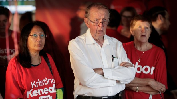 Labor supporters watching the news on television as the results roll in.