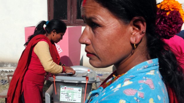 A Nepalese woman casts vote during the legislative elections in Balefi, Nepal, on Sunday.