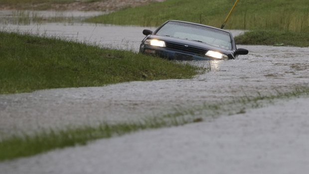 A car is partially submerged in floodwaters in Florence, South Carolina on Sunday.
