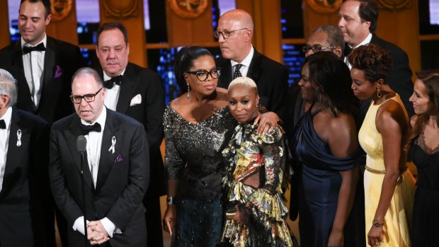 Producer Scott Sanders, left, accepts the Tony Award for best revival of a musical for 'The Color Purple' with his cast and creative team including Oprah Winfrey, centre.