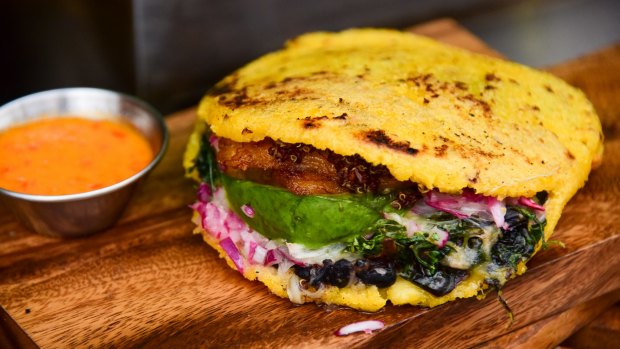 Arepas can be stuffed or topped with a variety of ingredients, from fresh cheese, to shredded meats, to egg or even beans.