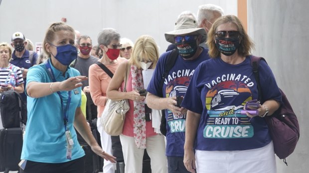 Orchid Klaric, left, assists Brenda and Kurt Duncan of Denver, with checking into their cruise,on Saturday.