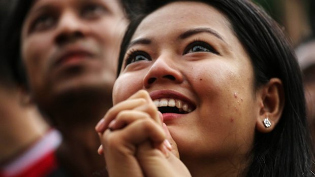 A National League for Democracy (NLD) supporter watching a screen showing the first election results coming through on Sunday. 