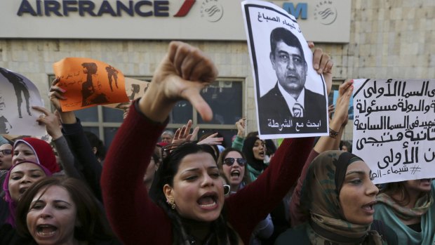 Protesters hold a poster of Egyptian Interior Minister Mohamed Ibrahim with the words "Wanted: the killer of Shaima al-Sabbagh"  in Cairo. Police have denied responsibility for her shooting.
