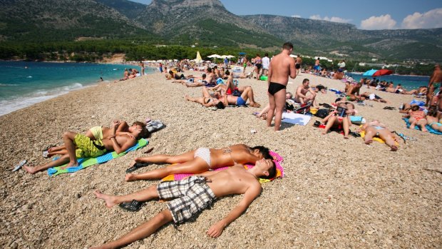Crowded beach of Zlatni Rat in Bol, Croatia. 