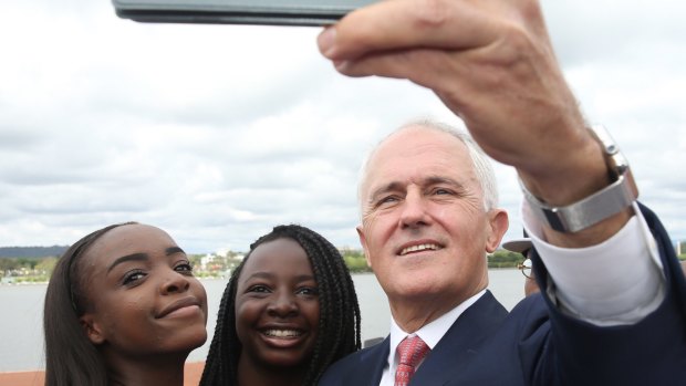 Prime Minister Malcolm Turnbull takes a selfie with new Australian citizens Lydia Banda-Mukuka and Chilandu Kalobi Chilaika after the citizenship ceremony on Australia Day this year.