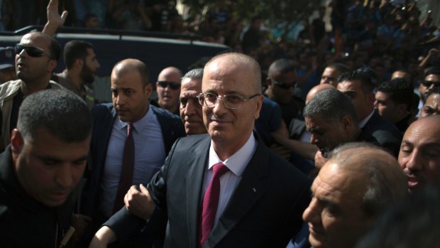 Palestinian PM Rami al-Hamdallah is surrounded by security during his visit to Gaza City.