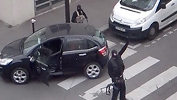 The Kouachi brothers gesture as they return to their car after the attack on French satirical weekly newspaper Charlie Hebdo.
