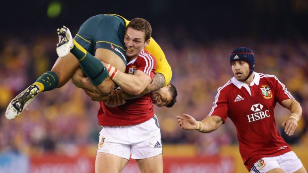 George North lifts Israel Folau as Leigh Halfpenny supports in Melbourne, 2013.