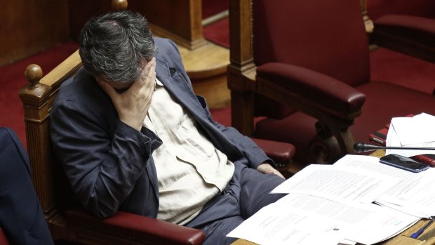 Tough day at the office ... Euclid Tsakalotos, Greece's finance minister, pauses while attending a parliamentary meeting in Athens.
