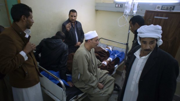 Relatives of Sheikh Sulieman Ghanem, 75, centre, surround him as he receives medical treatment on Friday.