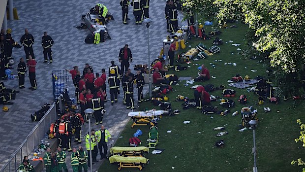 Fire fighters and emergency services gather at the building after the huge fire.