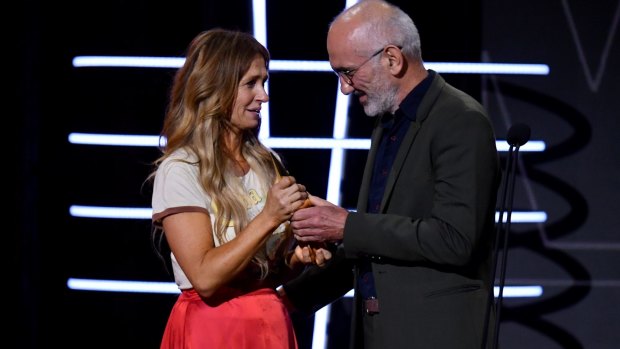 Paul Kelly presents Kasey Chambers with the Gold ARIA after she was inducted in to the ARIA Hall of Fame.
