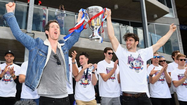 Howling success : Bulldogs Easton Wood and Robert Murphy show the trophy to the crowd during the grand final celebrations at Whitten Oval on Sunday. 