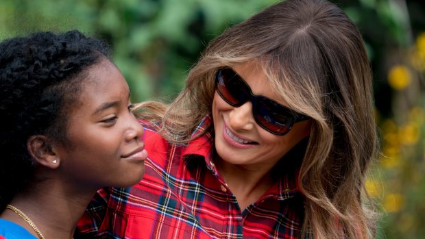 First lady Melania Trump hugs a school girl in the White House Kitchen Gardenin her first public foray into Michelle Obama's project.