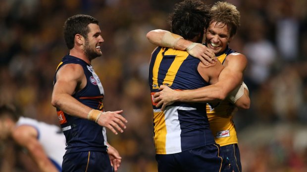 Mark LeCras and Josh Kennedy of the Eagles celebrate after defeating North Melbourne.