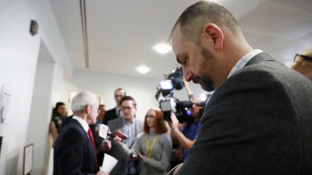 Sean Black listens during a Malcolm Roberts press conference.