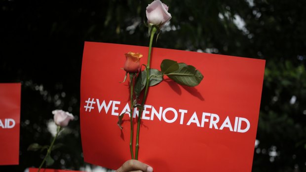 An activist holds a placard during a rally condemning the Jakarta attacks.