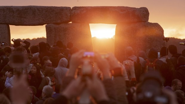The sun rises as thousands of revellers gathered at the ancient stone circle Stonehenge to celebrate the Summer Solstice near Salisbury, England.