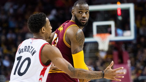  LeBron James looks for a pass while under pressure from Toronto's DeMar DeRozan.