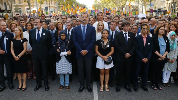 Spainish King Felipe, centre, Spainish Prime Minister Mariano Rajoy, third from left, and Catalonia regional President Carles Puigdemont, fourth from right, attend a demonstration condemning the Barcelona terrorist attacks.