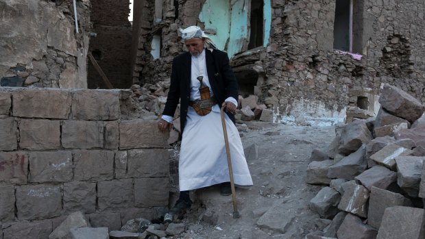 An elderly man passes destroyed homes in the old city of Sanaa in Yemen.
