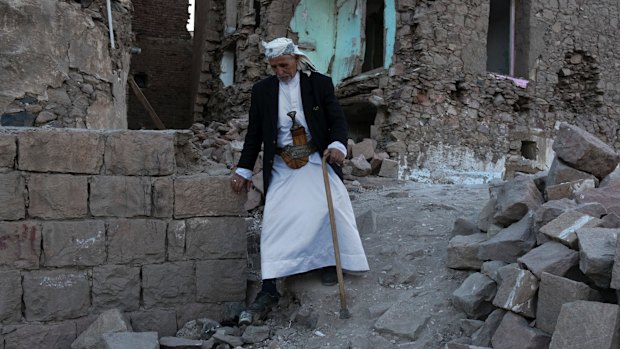 An elderly man passes destroyed homes in the old city of Sanaa in Yemen.