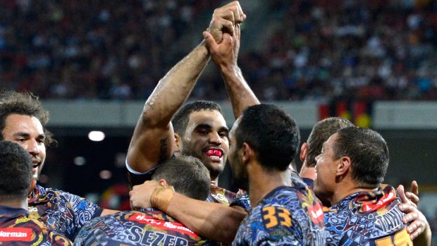 Proud people: Greg Inglis celebrates with Indigenous All Stars teammates in 2013.