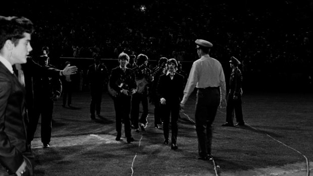 The Beatles walking to the stage at Candlestick Park in San Francisco.