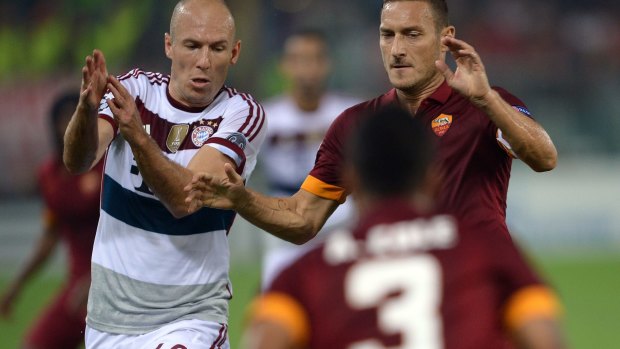 Bayern Munich's Arjen Robben leads Roma's Francesco Totti on a merry dance.